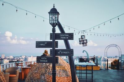 View of information sign against sky in city