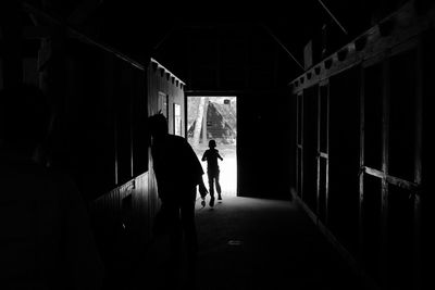 Rear view of silhouette kid walking in corridor