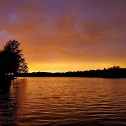Scenic view of lake against romantic sky at sunset