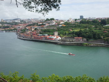 High angle view of buildings by sea against sky