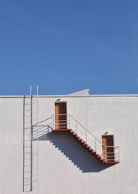Low angle view of building against clear blue sky
