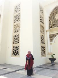 Full length of woman in hijab standing at mosque