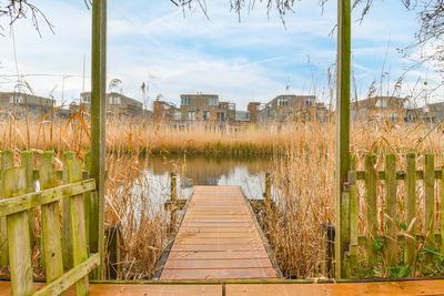 Pier over lake against sky