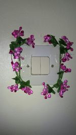 Close-up of artificial flowers against wall