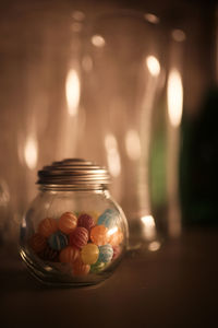 Close-up of candles in glass jar on table