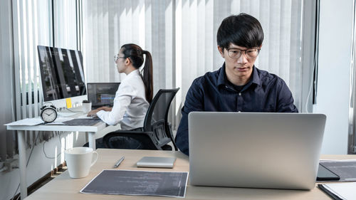 Young man using laptop at office