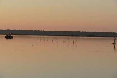 Scenic view of lake against orange sky