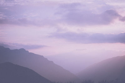 Scenic view of mountains against sky during foggy weather