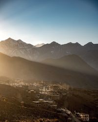 High angle shot of townscape against mountain range at sunset