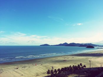 Scenic view of beach against blue sky