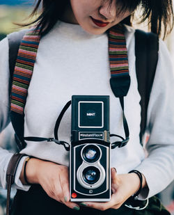 Midsection of woman photographing