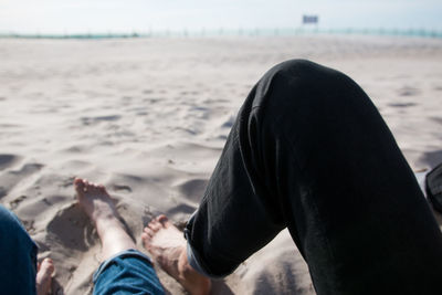 Low section of people relaxing at beach