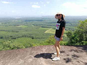 Full length of young woman standing on land