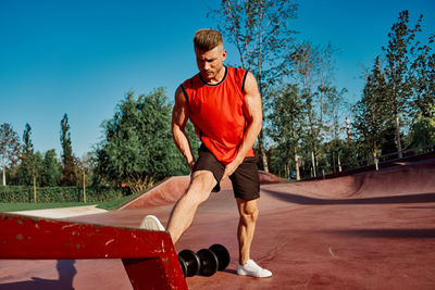 Side view of man exercising on field