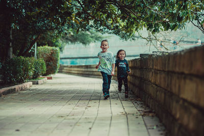 Two happy children run forward