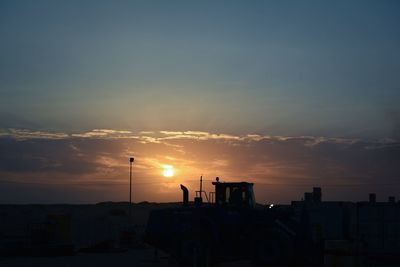 Cars against sky during sunset