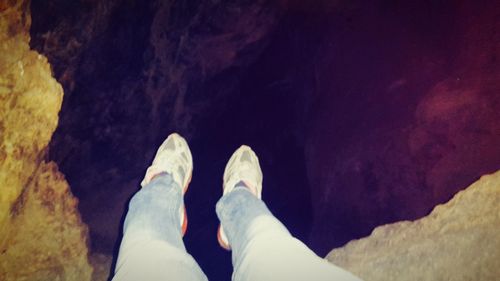 Low section of man standing on rock