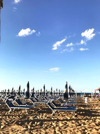 Panoramic view of beach umbrellas against sky