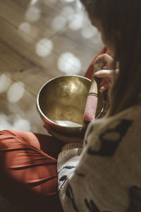 Close up on  a woman meditating with the tibetan bowl