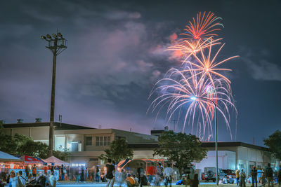 Low angle view of firework display at night