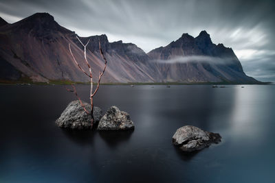 Scenic view of lake and mountains against sky