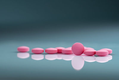 Close-up of pills over turquoise background