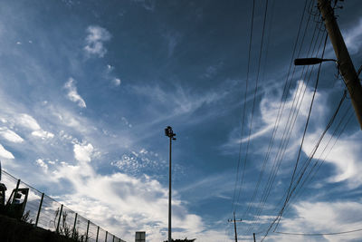 Low angle view of street lights against sky