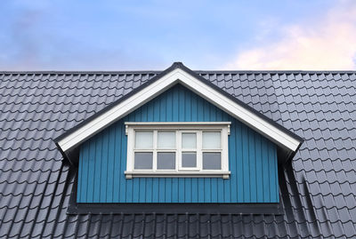 Roof window in velux style with roof tiles - icelandic architecture