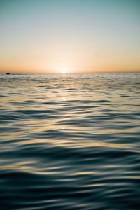 Scenic view of sea against clear sky during sunset