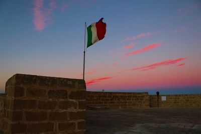 Low angle view of flags against sky