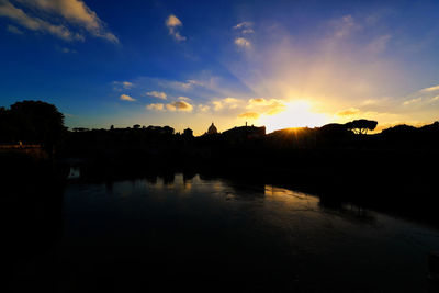 Scenic view of river at sunset