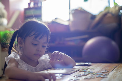 Portrait of girl looking at table