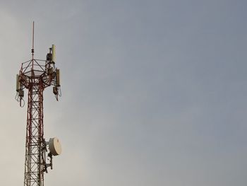 Low angle view of communications tower against sky