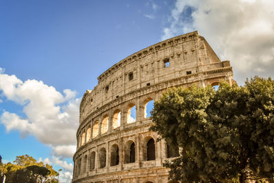 Low angle view of historical building against cloudy sky colloseum