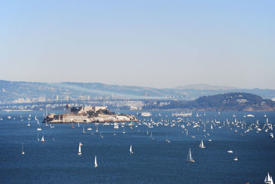 High angle view of boats in sea against clear sky