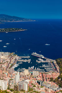 High angle view of townscape by sea against sky