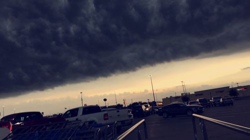 View of road against cloudy sky at sunset