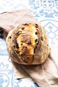 Homemade freshly baked sourdough bread with olives. close up.