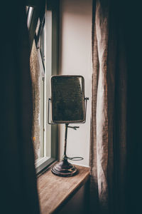 Mirror on window sill at home