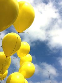 Low angle view of balloons against sky