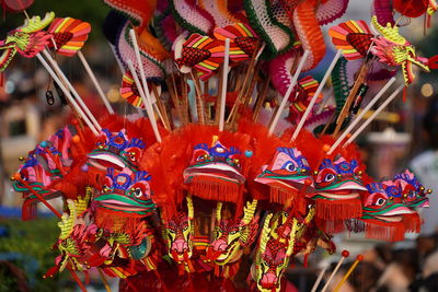 Close-up of multi colored pencils in traditional clothing for sale