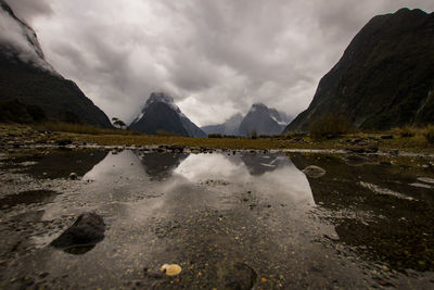 Scenic view of lake and mountains against sky