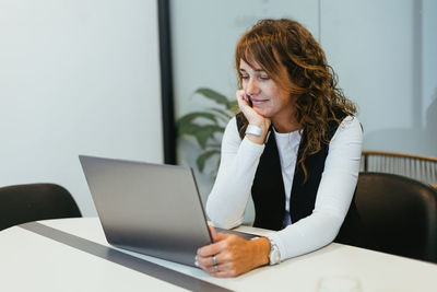 Young woman using laptop at home