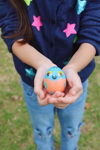 Midsection of girl holding easter egg