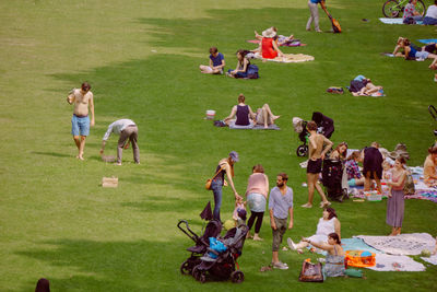 High angle view of people relaxing on field