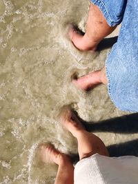 Low section of person standing on beach