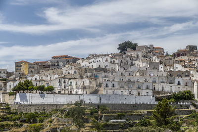 Buildings in town against sky