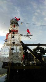 Low angle view of decoration hanging against sky