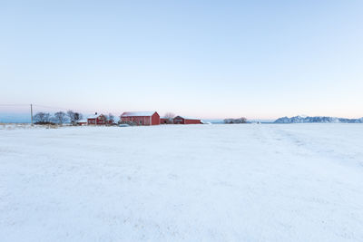 Scenic view of snow covered landscape against clear sky