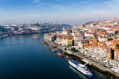 High angle view of river by cityscape against sky